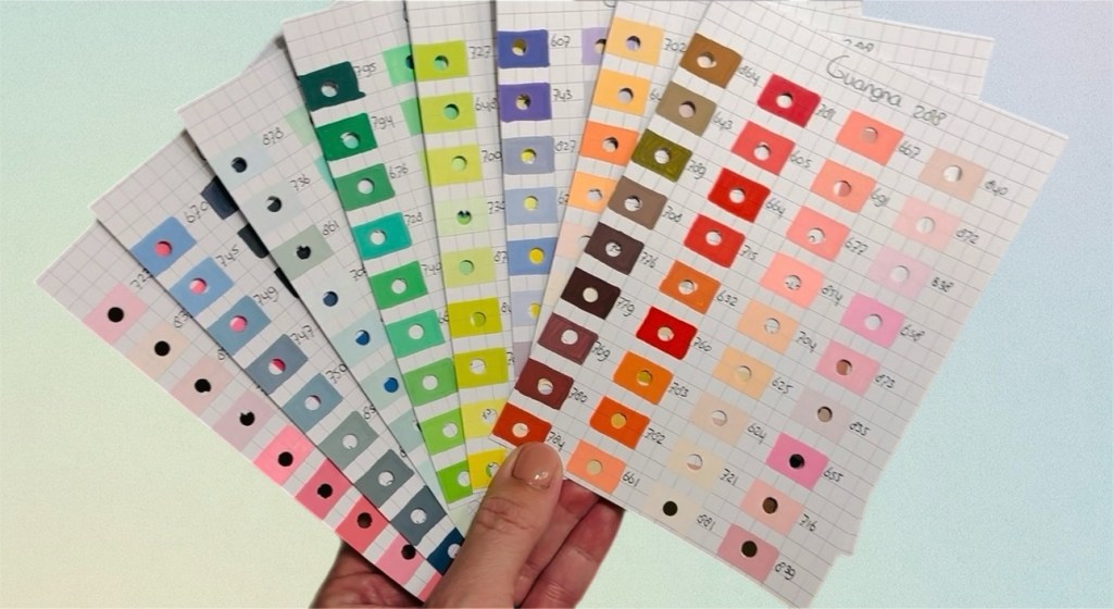 Een hand die 8 kleurkaarten vast houdt