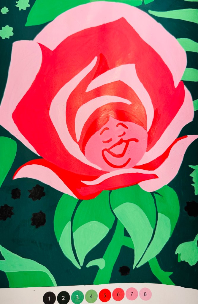 De kleurplaat ingekleurd: je ziet nu een bloem met een gezichtje erin