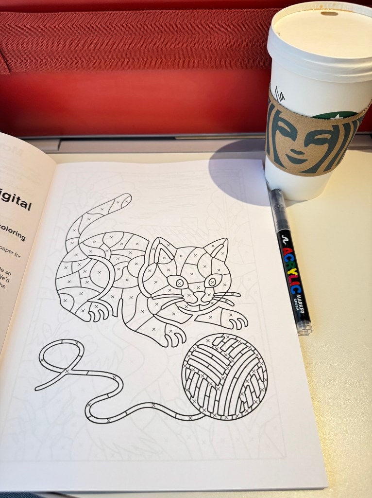 Een kleurplaat van een kat met een bolletje wol, nog niet ingekleurd