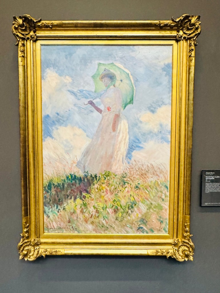 Het schilderij Vrouw met parasol van Monet